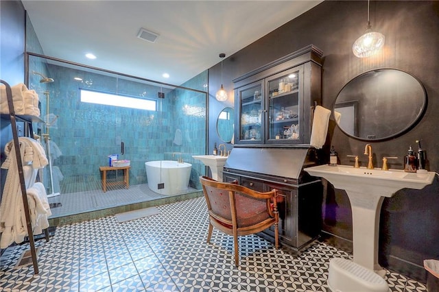 bathroom with a freestanding tub, a shower stall, visible vents, and recessed lighting