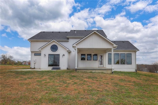 rear view of house with a patio and a yard