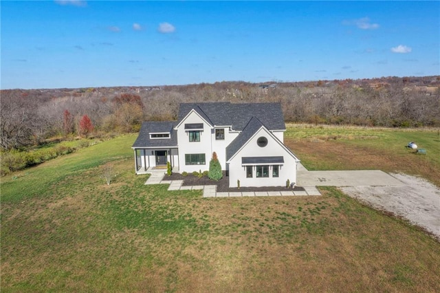 modern farmhouse style home featuring a front lawn and a porch