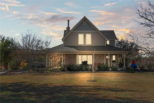 view of front of property featuring a yard and covered porch