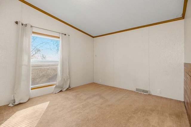 carpeted spare room featuring lofted ceiling and ornamental molding