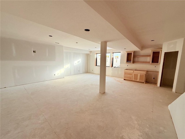 unfurnished living room featuring concrete floors