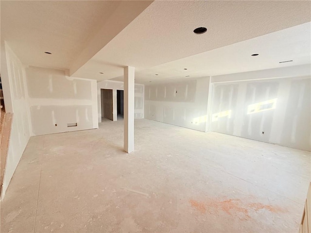 unfurnished room featuring a textured ceiling