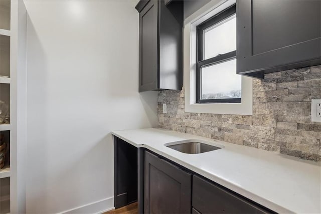 kitchen featuring backsplash, sink, and dark hardwood / wood-style floors