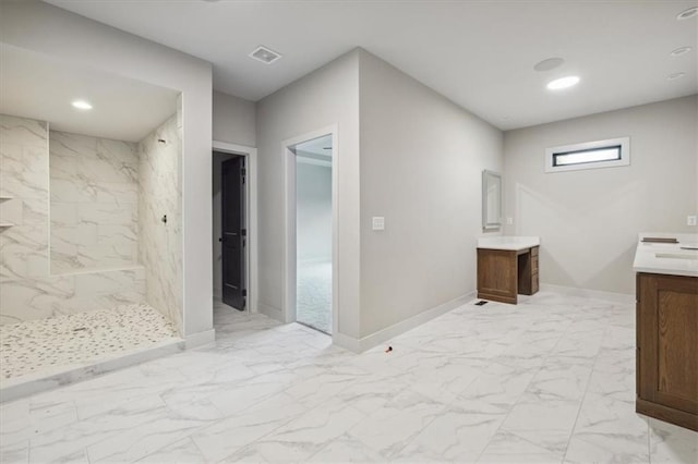 bathroom featuring vanity and a tile shower