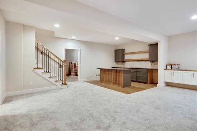 kitchen with a kitchen island and light colored carpet