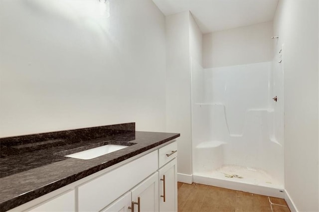 bathroom with vanity and a shower