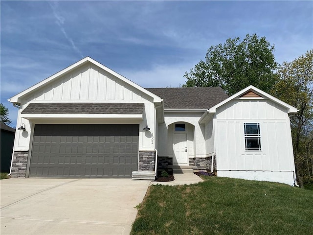 view of front of property with a front lawn and a garage