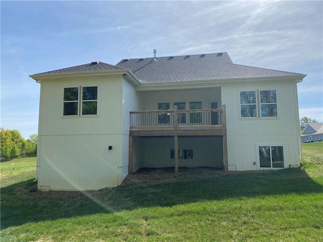 back of house featuring a yard and a balcony