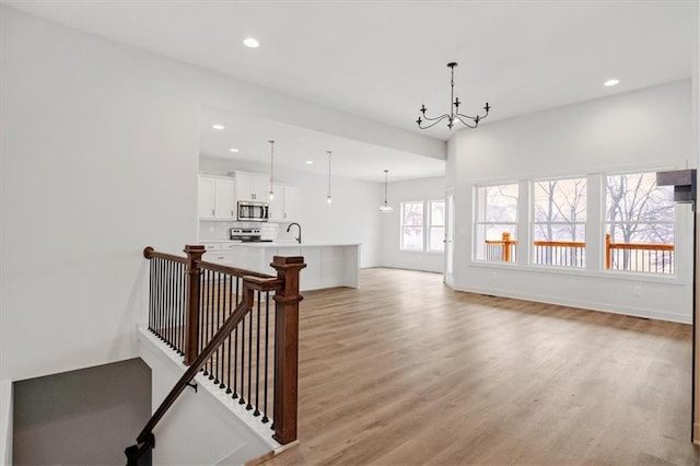 interior space featuring a notable chandelier and wood-type flooring