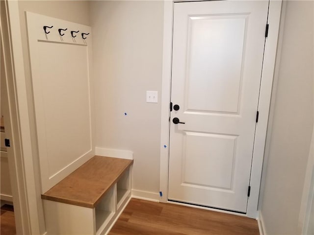 mudroom featuring baseboards and wood finished floors