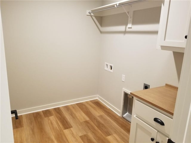 laundry area featuring electric dryer hookup, cabinets, light wood-type flooring, and hookup for a washing machine