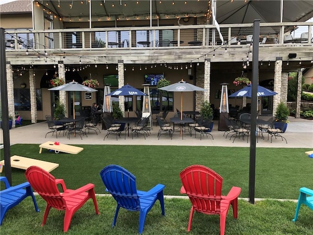 exterior space featuring a balcony and a lawn