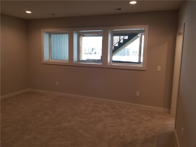 carpeted spare room with recessed lighting, visible vents, and baseboards