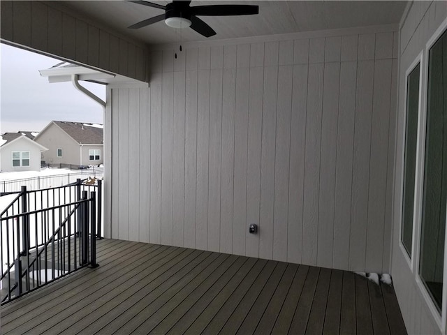 wooden terrace featuring ceiling fan and fence