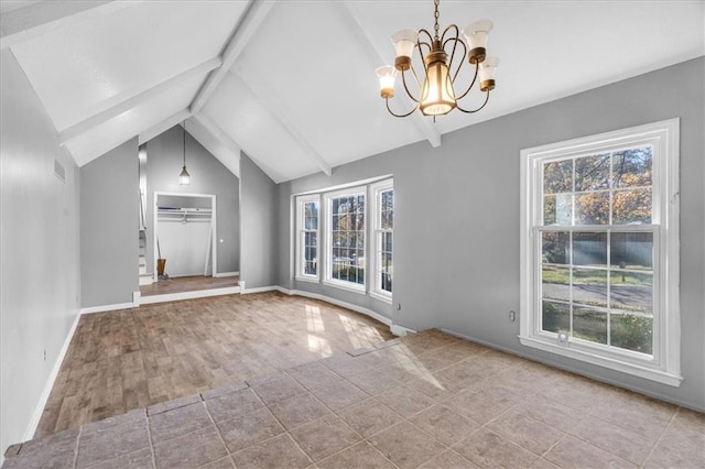 interior space with plenty of natural light, lofted ceiling with beams, ceiling fan with notable chandelier, and light hardwood / wood-style flooring