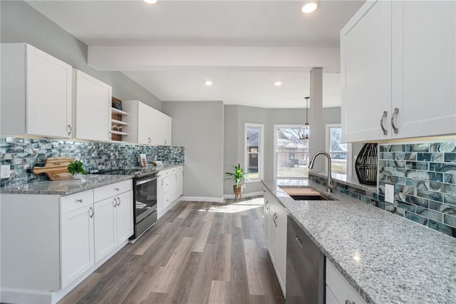 kitchen featuring light hardwood / wood-style flooring, hanging light fixtures, stainless steel appliances, light stone countertops, and white cabinets