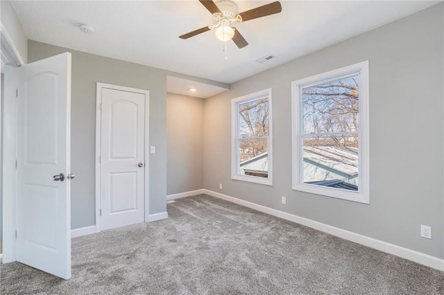 unfurnished room featuring carpet floors and ceiling fan