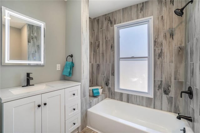 bathroom with vanity and tiled shower / bath