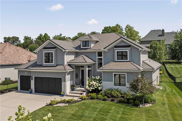 view of front facade featuring a front yard and a garage