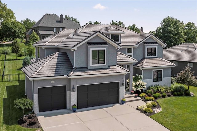 view of front of home featuring a front yard and a garage