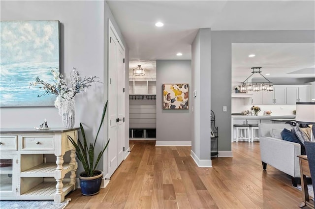 hallway with light hardwood / wood-style flooring