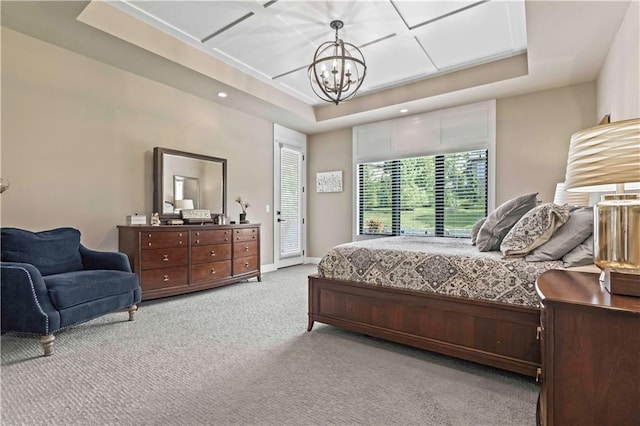 bedroom with a notable chandelier, coffered ceiling, light carpet, and a tray ceiling