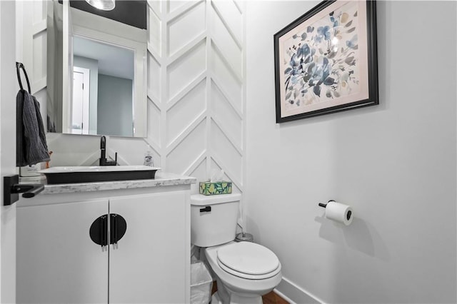 bathroom featuring toilet and vanity