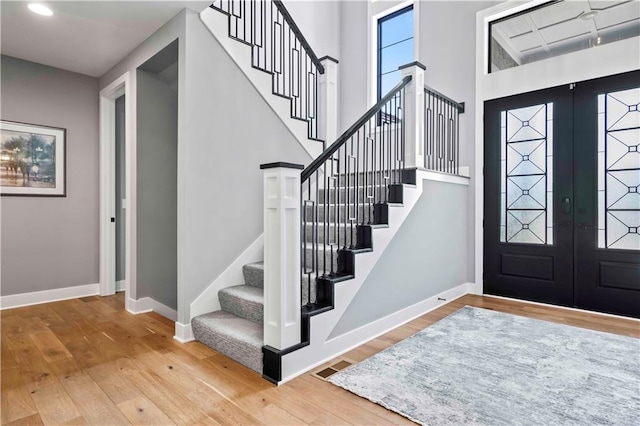 entrance foyer with french doors and hardwood / wood-style floors