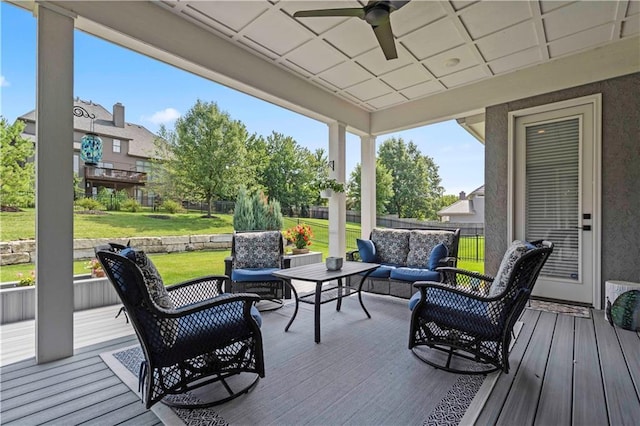 deck featuring ceiling fan, a yard, and outdoor lounge area