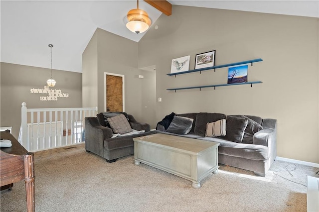 carpeted living room featuring beamed ceiling and high vaulted ceiling