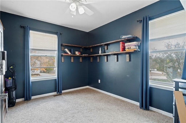 carpeted empty room featuring ceiling fan