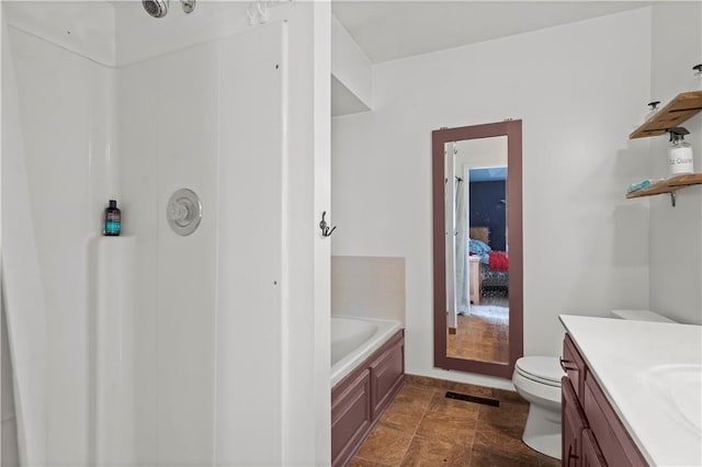 bathroom featuring vanity, toilet, and a tub