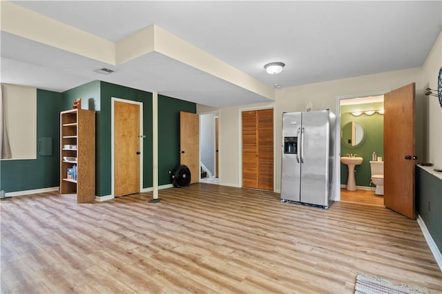 kitchen with sink, light hardwood / wood-style floors, and stainless steel fridge with ice dispenser