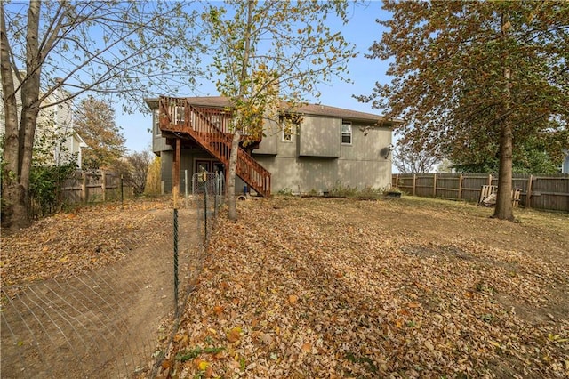 back of house with a deck