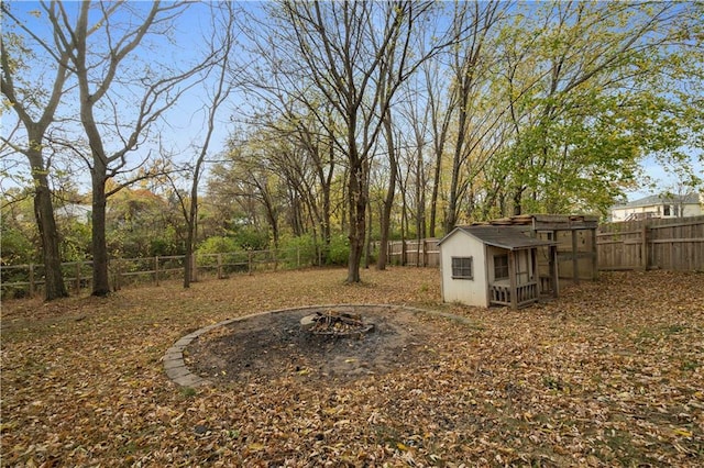 view of yard featuring a shed and a fire pit