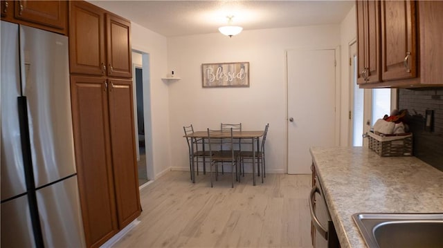 kitchen with light wood-type flooring and stainless steel appliances