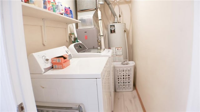 washroom with separate washer and dryer, water heater, and heating unit