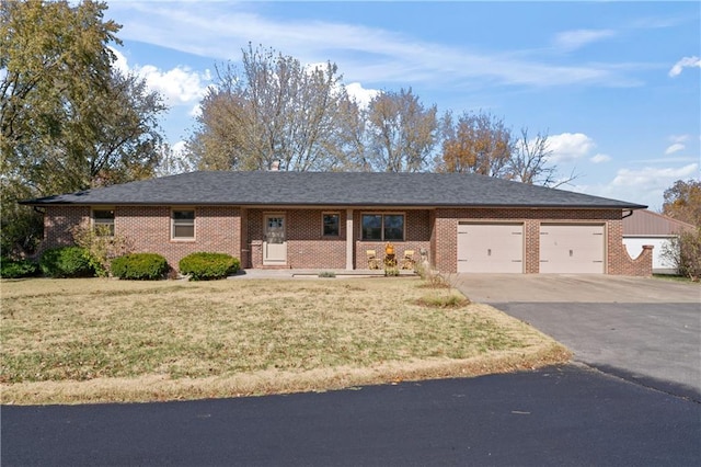 ranch-style home with a garage and a front yard