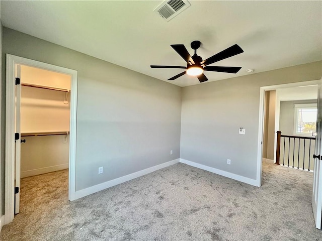 empty room with light colored carpet and ceiling fan