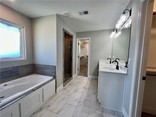 bathroom with vanity and independent shower and bath