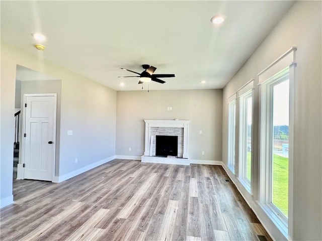 unfurnished living room featuring ceiling fan and light hardwood / wood-style floors