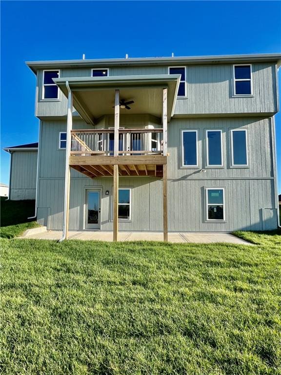 back of house with a patio, ceiling fan, and a lawn