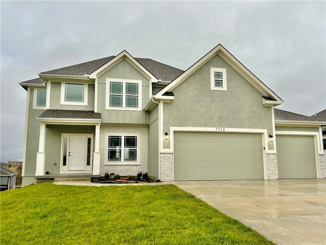 view of front of property featuring a front yard and a garage