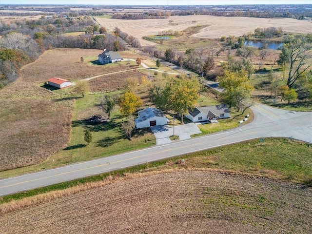 birds eye view of property featuring a water view and a rural view