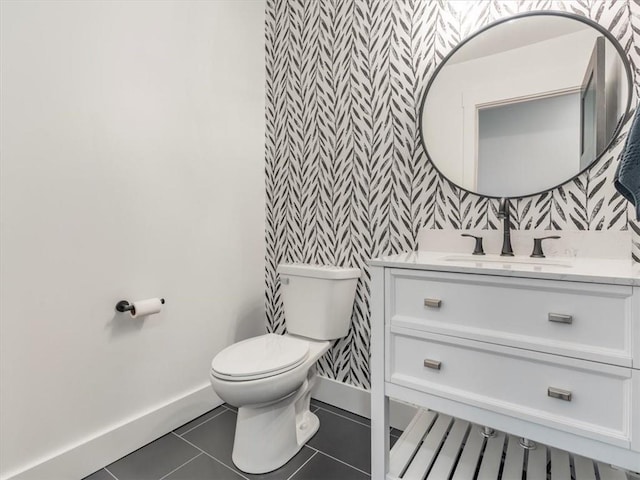 bathroom with tile patterned flooring, vanity, and toilet