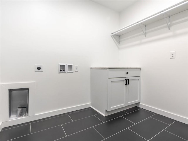 washroom featuring electric dryer hookup, dark tile patterned floors, and washer hookup