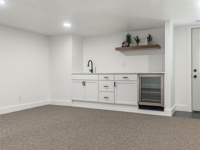 bar featuring white cabinets, carpet floors, wine cooler, and sink