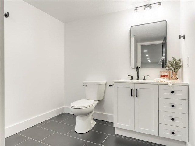 bathroom with tile patterned floors, vanity, and toilet