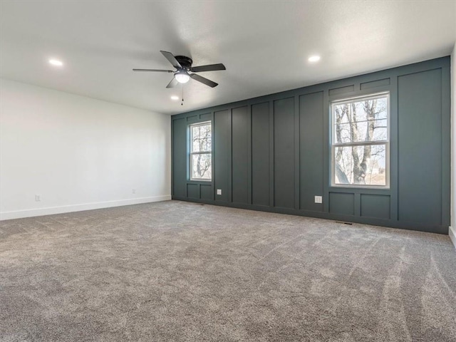 empty room featuring ceiling fan and carpet floors